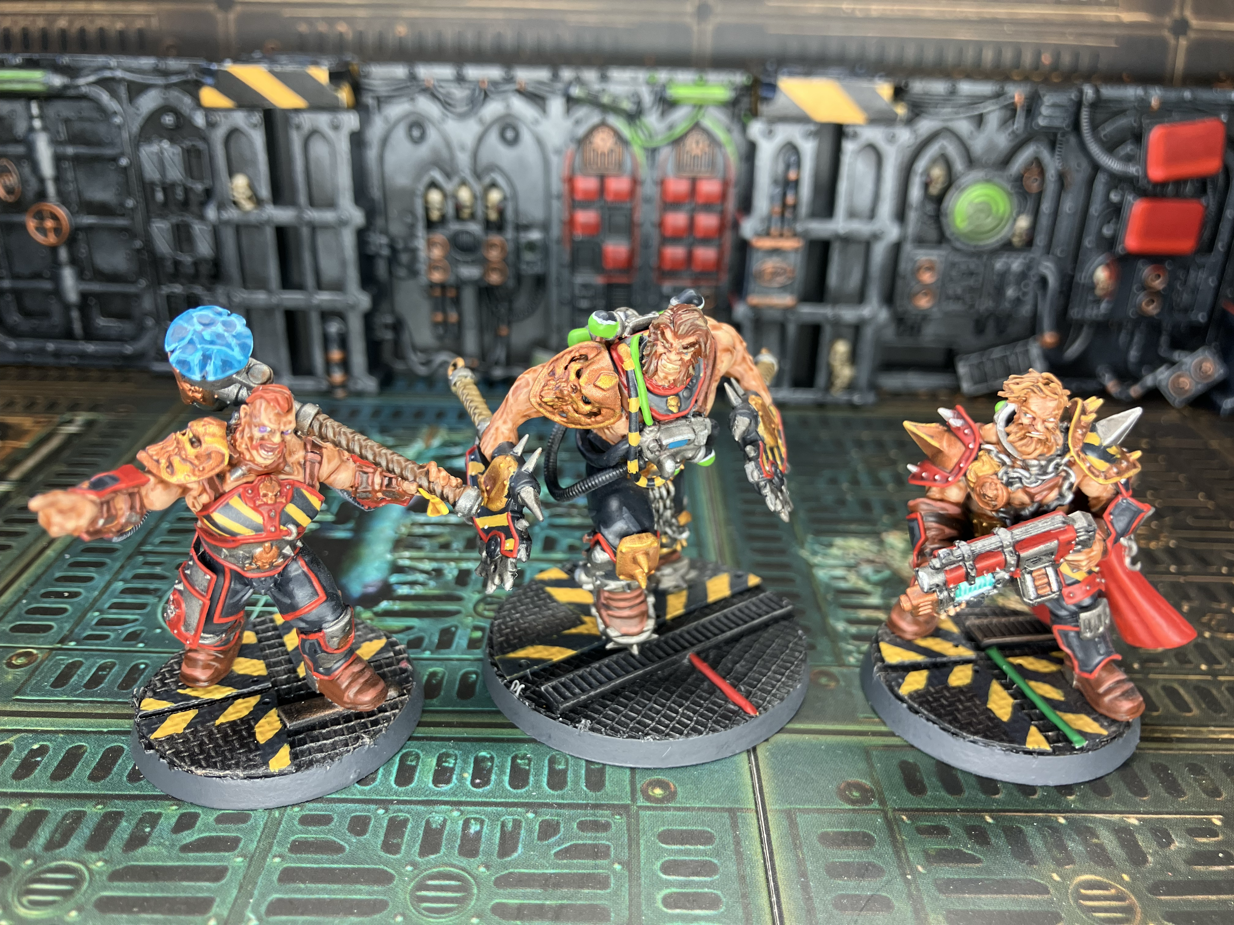 Three Goliath champions, each sporting hazard stripes.