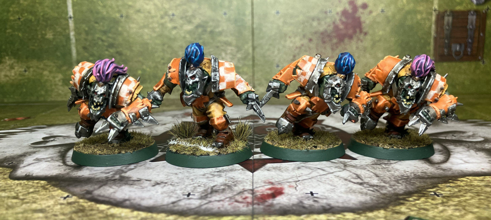 Four Blood Bowl orc blitzers