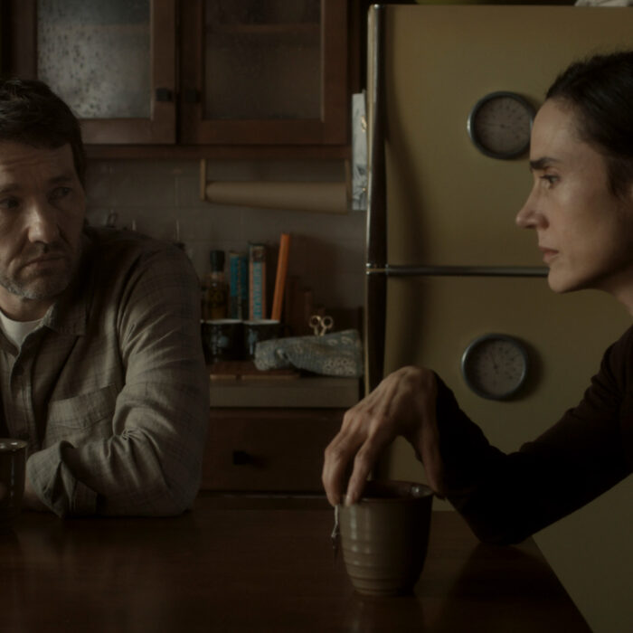 Jason and Daniella sit at their kitchen table in 1970's world in Dark Matter