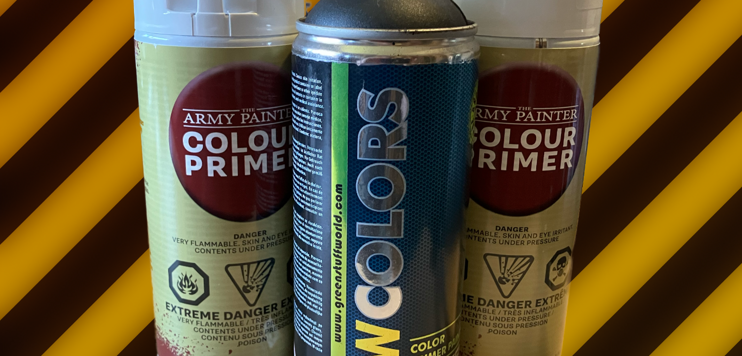 Two cans of Army Painter and a can of Green Stuff World primer on a hazard stripe background.