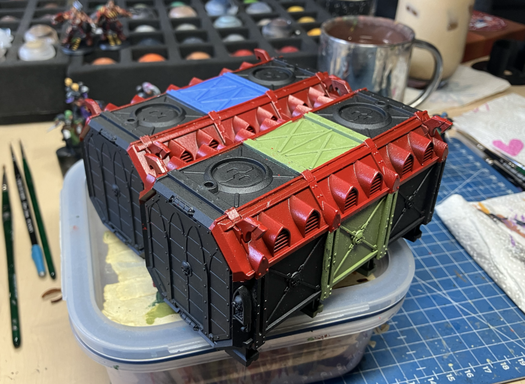 Two Munitorum Containers after being masked and painted with a rattle can.
