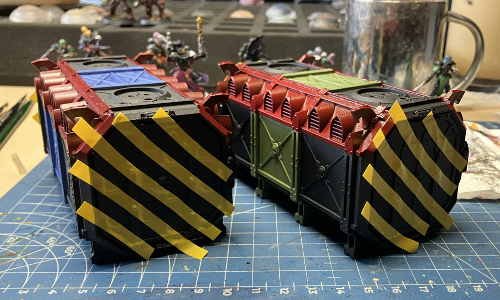 Two Munitorum Containers masked off for hazard stripes
