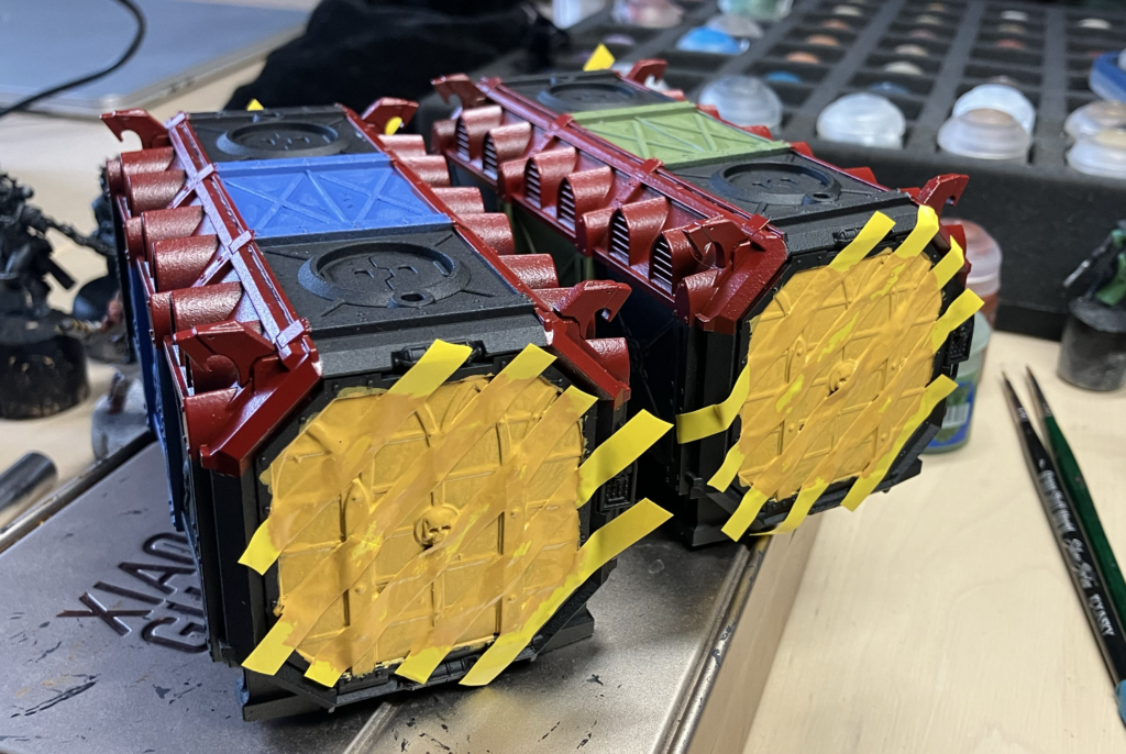 Two Munitorum Containers masked off and painted