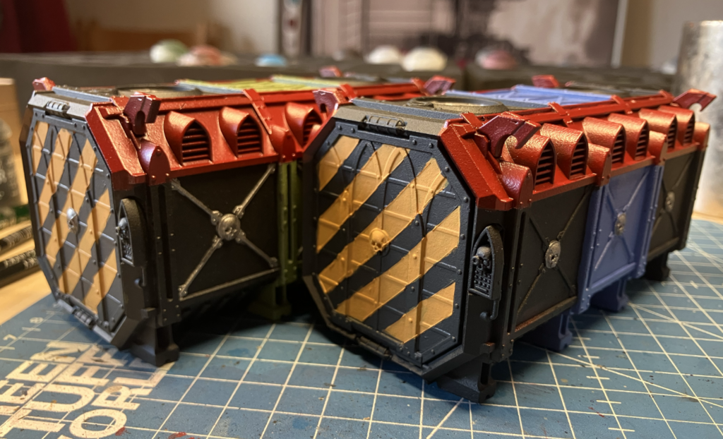 Two Munitorum Containers with their hazard stripes cleaned up.